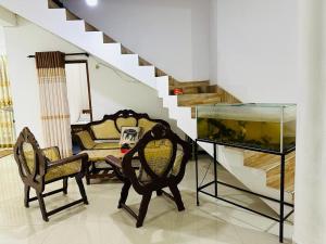un soggiorno con 2 sedie e un acquario di LOTUS HOLIDAY REST a Anuradhapura