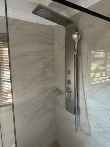 a bathroom with a shower with a glass door at Kimberley Boutique Guest Lodge in Kimberley +17 photos