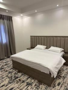 A bed or beds in a room at بودل روز