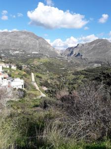 a view of a valley with mountains in the background at House of South in Yiannioú