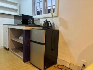 a kitchen with a small refrigerator and a counter at Mt Eden Tidy Unit B in Auckland