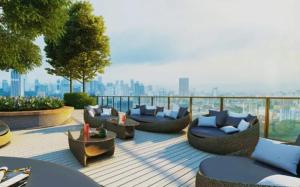 a patio with couches and tables and a city skyline at M Vertica kl 3r2b 7 pax cosy house 3min mrt, sunway velocity mall, 8min ikea in Kuala Lumpur
