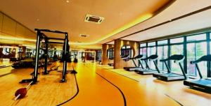 a gym with cardio equipment in a building at M Vertica kl 3r2b 7 pax cosy house 3min mrt, sunway velocity mall, 8min ikea in Kuala Lumpur