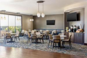 a conference room with tables and chairs and a tv at Residence Inn by Marriott Youngstown Warren/Niles in Niles