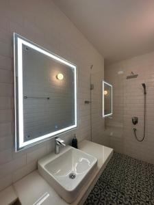 a bathroom with a large window above a sink at Oceanic - Luxury Boutique Hotel in Palolem