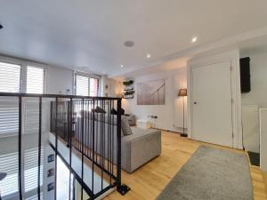 a living room with a couch and a stair case at Deluxe Townhouse Zone 1 Brick Lane in London