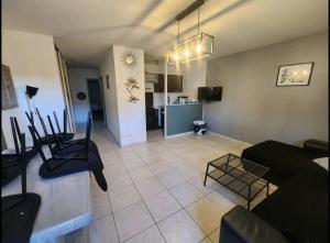 a living room with a couch and a table at Maison de ville proche Le Portel 2 chambres in Outreau
