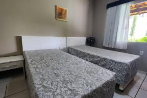 En eller flere senge i et værelse på Casa Escarpas do Lago - Capitólio - MG + 9 billeder