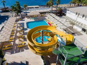 an overhead view of a pool with a slide at Petunya Beach Resort in Ortakent