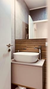 a bathroom with a white sink and a mirror at Skylark - Monaco Penthouse with Jacuzzi & Panoramic View in Braşov +20 photos