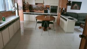 a kitchen with a wooden table and a table at Apartamento Retro in Sagunto