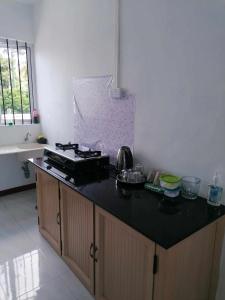 a kitchen with a stove and a counter top at Family Residence in Grande Rivière Sud Est