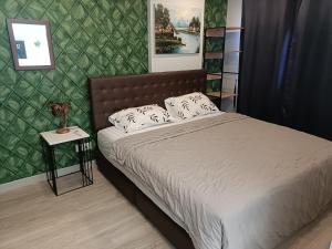 a bedroom with a bed and a green wall at The Marvest Hua Hin in Hua Hin +15 photos