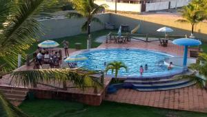 a pool at the resort with people in it at Vila Real in São Mateus