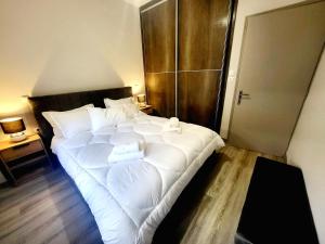 a large white bed in a room with a wooden floor at Helios Houses - Ioannina in Ioannina +22 photos