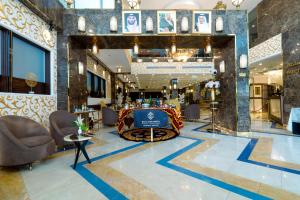 a lobby with chairs and a bar in the center at فندق النجم الأزرق - Blue star hotel in Jeddah