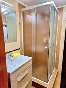 a bathroom with a shower and a sink at Angyal Apartman Gyula in Gyula +24 photos