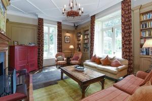 a living room with a couch and a table at The Old Rectory in Kings Lynn