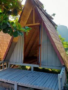 a smallshed with a wooden door on top of a bench at NongKhiaw CampingSite Swimming Pool in Ban Nongkham