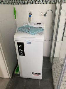 a small washing machine in a bathroom with a shower at FeWoMonCIAO2019-Panorama 2Pers bis max4Pers in Monschau