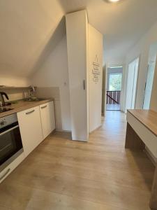 a kitchen with white cabinets and a counter top at Apartments Heart in Ljubljana