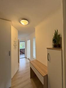 a hallway of a house with a bench and a window at Apartments Heart in Ljubljana