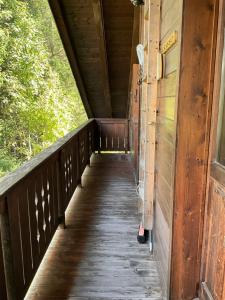 a walkway on the side of a wooden bridge at CHALET STRAVEDO in Villanova