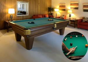 a living room with a pool table and a room with at RusticParaiso: Family, Team & Group Urban Retreat in Greensboro