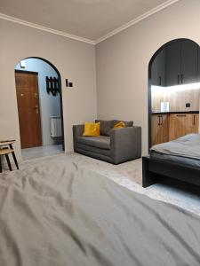 a living room with a couch and a mirror at Medyka Loft in Medyka