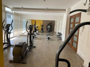 a gym with a bunch of treadmills and machines at Hermosa y Cómoda Habitación in Santiago