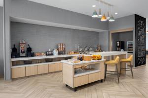 a large kitchen with a counter and chairs in it at TownePlace Suites by Marriott Sacramento Rancho Cordova in Rancho Cordova