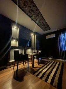 a living room with a table and a chair at Hotel sofra in Ferizaj +14 photos