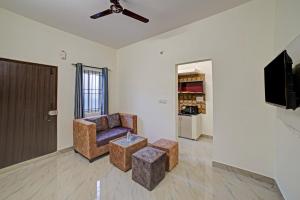 a living room with a couch and a tv at Collection O Sunshine Studio Rooms in Bangalore