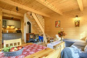 a kitchen and a living room with a table in a cabin at Tylickie Chałupy in Tylicz +13 photos