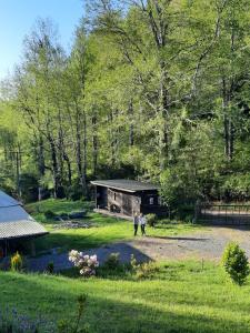 two people walking in front of a house at Casa Pucon sector Laguna ancapulli in Pucón