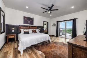 a bedroom with a bed and a ceiling fan at Serenity Shores Resort - Luxury Lakefront Lodge - Pools and Many Free Amenities in Kimberling City