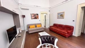 a living room with a couch and a tv at Il Duomo e il Mare in Brindisi