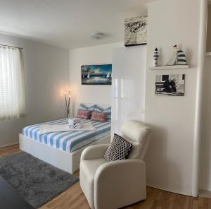 a small bedroom with a bed and a chair at Studio Apartment Pag Luxury 4U in Pag +19 photos