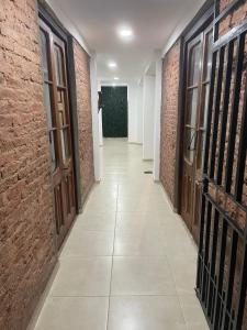 a corridor of a building with brick walls and doors at Pucara Apart - Habitaciones con baño privado in Corrientes