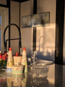 a kitchen counter with milk bottles and a sink at Villa Henrikke Myhre in Osøyro