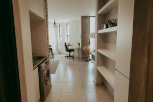 a hallway with a washer and dryer in a room at Luxury Apartment near Grove Mall & Hospital Airbnb VELDT Suite in Windhoek