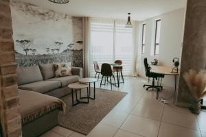 a living room with a couch and a table at VELDT Suite - Luxury Apartment near Grove Mall & Hospital Airbnb in Windhoek
