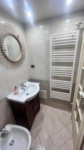 a bathroom with a sink and a mirror at Il Duomo e il Mare in Brindisi +37 photos
