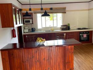 a kitchen with a bowl of fruit on a counter at Mokara Holiday Apartment in Mahe