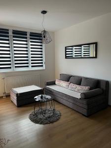 a living room with a couch and a table at Apartman Maša in Ruma