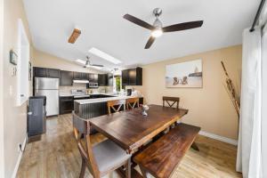 a kitchen and dining room with a wooden table at 3 bedrooms waterfront Cottage in Parry Sound