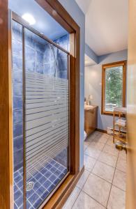 a bathroom with a sliding glass door with a window at Le Domaine de l'Étang in Frampton