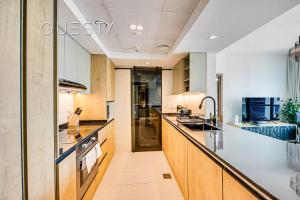 a kitchen with wooden cabinets and a counter top at Park Island, Dubai Marina in Dubai