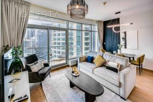 a living room with a couch and a table at Park Island, Dubai Marina in Dubai