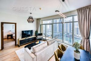 a living room with a couch and a large window at Park Island, Dubai Marina in Dubai